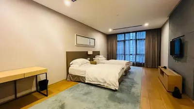 a bedroom with a bed and a flat screen tv at KLCC Luxury 2BR 188 Suites in Kuala Lumpur