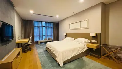 a bedroom with a bed and a desk and a television at KLCC Luxury 2BR 188 Suites in Kuala Lumpur