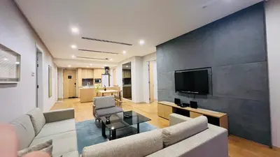 a living room with a couch and a tv at KLCC Luxury 2BR 188 Suites in Kuala Lumpur