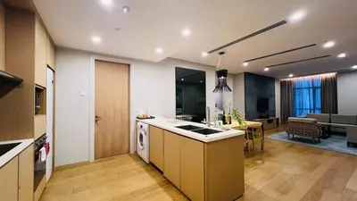 a kitchen and living room with a counter and a stove at KLCC Luxury 2BR 188 Suites in Kuala Lumpur
