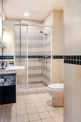 a bathroom with a shower and a toilet and a sink at Seri Bukit Ceylon Bukit Bintang in Kuala Lumpur