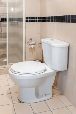 a white toilet in a bathroom with a shower at Seri Bukit Ceylon Bukit Bintang in Kuala Lumpur