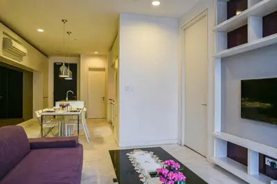 a living room with a couch and a table at Sama Suites at Platinum KLCC Bukit Bintang in Kuala Lumpur