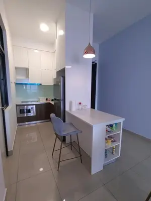a kitchen with a table and a chair in a room at Service Apartment Sunway Velocity in Kuala Lumpur
