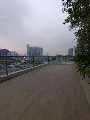 a large wooden deck with a view of a city at Service Apartment Sunway Velocity in Kuala Lumpur