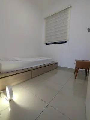 a white room with a bed and a window at Service Apartment Sunway Velocity in Kuala Lumpur