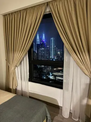 a bedroom with a window with a view of a city at Agile Milestone service suite TRX by KL in Kuala Lumpur