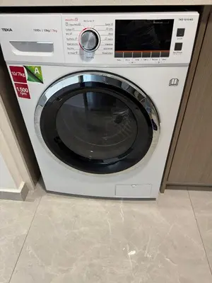 a white washing machine sitting in a kitchen at Agile Milestone service suite TRX by KL in Kuala Lumpur