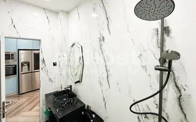 a shower in a bathroom with a marble wall at Family House at Setiawangsa by Airhost in Kuala Lumpur