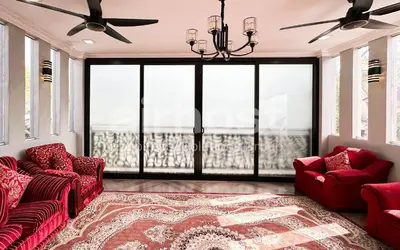 a living room with two red chairs and a large window at Family House at Setiawangsa by Airhost in Kuala Lumpur