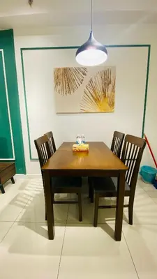 a dining room with a wooden table and chairs at Chamber suites KLCC by Global stay in Kuala Lumpur
