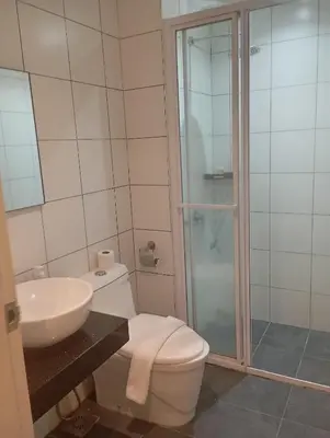 a bathroom with a toilet and a sink and a shower at Chamber suites KLCC by Global stay in Kuala Lumpur