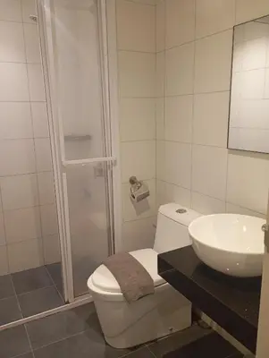 a white bathroom with a toilet and a sink at Chamber suites KLCC by Global stay in Kuala Lumpur