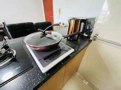 a pan sitting on top of a stove on a counter at 231TR Service Suites by DeUrban in Kuala Lumpur