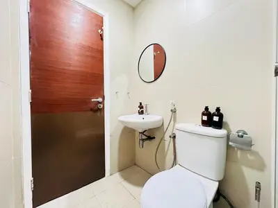 a bathroom with a toilet and a sink at 231TR Service Suites by DeUrban in Kuala Lumpur