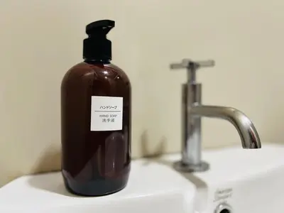 a bottle of soap sitting on top of a sink at 231TR Service Suites by DeUrban in Kuala Lumpur