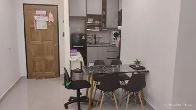 a room with a table and chairs and a kitchen at Setapak KL Apt 2 Room Mus'lim in Kuala Lumpur