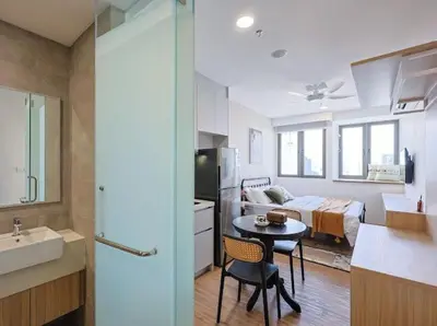 a room with a kitchen and a bedroom with a bed at KL Sentral city retreats with KLCC views in Kuala Lumpur
