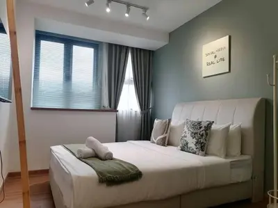a bedroom with a large white bed and windows at KL Sentral city retreats with KLCC views in Kuala Lumpur