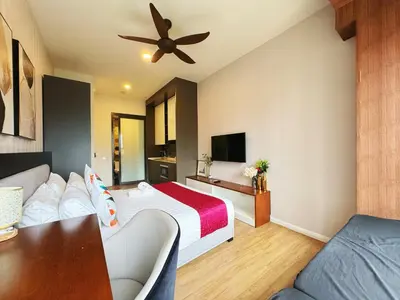 a hotel room with a bed and a ceiling fan at Ceylonz Suites KLCC by WSD in Kuala Lumpur