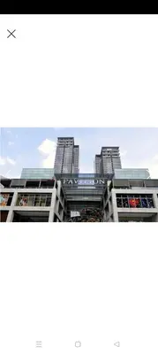 a view of a building with tall buildings in the background at Summer Suites By SmartWill in Gua Sai