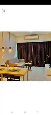 a living room with a couch and a table at Summer Suites By SmartWill in Gua Sai