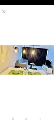 a living room with a couch and a table at Summer Suites By SmartWill in Gua Sai