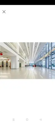 an empty hallway of a large building with windows at Summer Suites By SmartWill in Gua Sai