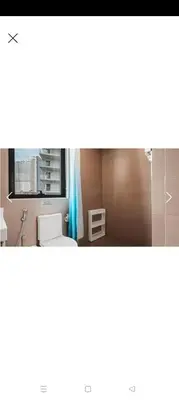a bathroom with a sink and a window at Summer Suites By SmartWill in Gua Sai