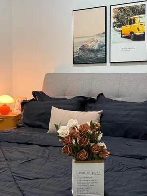 a bed with a vase of flowers on it at Razak City Kuala Lumpur A2-30 in Kuala Lumpur
