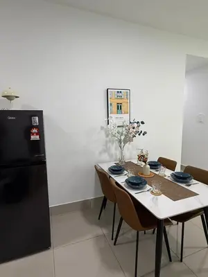 a dining room with a table and a black refrigerator at Razak City Kuala Lumpur A2-30 in Kuala Lumpur