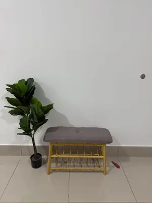 a bench sitting on a floor next to a plant at Razak City Kuala Lumpur A2-30 in Kuala Lumpur