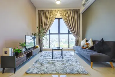 a living room with a couch and a tv at Trion Kuala Lumpur by Vivid Stay in Kuala Lumpur