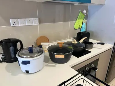 a kitchen counter with pots and pans on a stove at Trion Kuala Lumpur by Vivid Stay in Kuala Lumpur