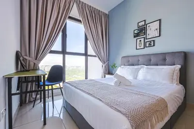 a bedroom with a bed and a desk and a window at Trion Kuala Lumpur by Vivid Stay in Kuala Lumpur