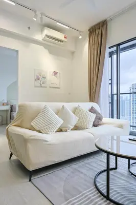 a living room with a white couch and a table at Trion Kuala Lumpur by Vivid Stay in Kuala Lumpur