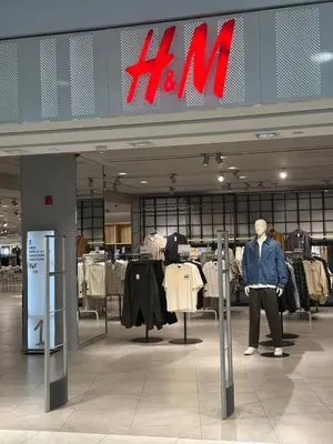 a man standing in front of a hm store at Quill Residence- Minimalist Urban Condo by Azmila in Kuala Lumpur
