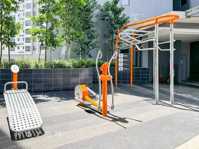 an orange exercise machine and a bench in front of a building at SBR1B Hozem KL2601 Apartment Bukit Bintang in Kuala Lumpur