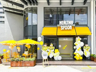 a restaurant with yellow umbrellas in front of a store at SBR1B Hozem KL2601 Apartment Bukit Bintang in Kuala Lumpur