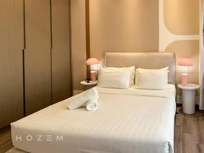 a bedroom with two beds with white sheets and pink lamps at 2BR1B Hozem KL4409 Apartment Bukit Bintang in Kuala Lumpur