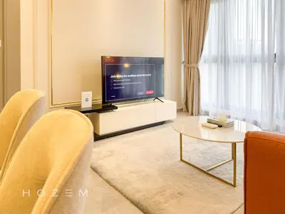 a living room with a television and a table at 2BR2B Hozem KL1812 Apartment Bukit Bintang in Kuala Lumpur