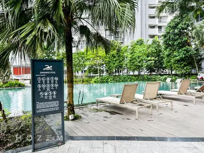 a group of lounge chairs sitting next to a pool at 2BR2B Hozem KL4906 Apartment Bukit Bintang in Kuala Lumpur