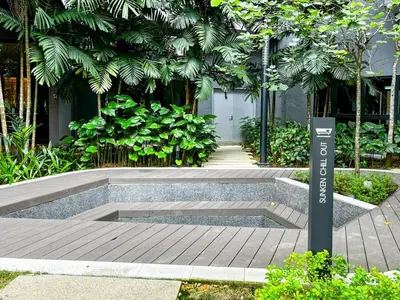 a bench in a garden with a sign on it at 2BR2B Hozem KL4906 Apartment Bukit Bintang in Kuala Lumpur