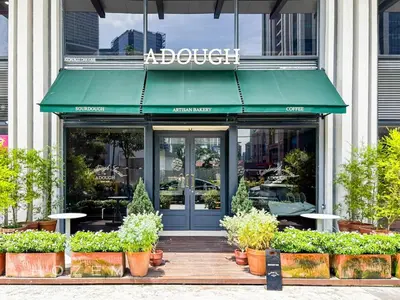 a store front with a green awning and plants at 2BR2B Hozem KL1713 Apartment Bukit Bintang in Kuala Lumpur