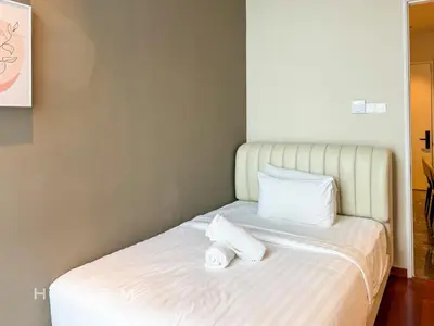 a bed with two towels sitting on top of it at 2BR2B Hozem KL3802 Apartment KLCC in Kuala Lumpur