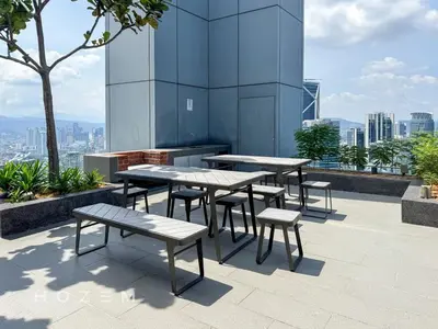 a group of tables and benches on top of a building at 2BR2B Hozem KL4207 Apartment KLCC in Kuala Lumpur
