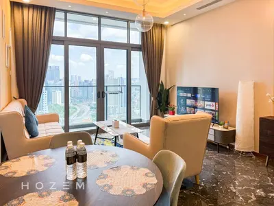 a hotel room with tables and chairs and a large window at 2BR2B Hozem KL3709 Apartment KLCC in Kuala Lumpur