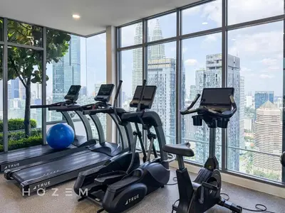 a gym with cardio machines and a large window at 2BR2B Hozem KL3709 Apartment KLCC in Kuala Lumpur