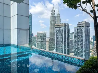 a swimming pool on the roof of a building with a city at 2BR2B Hozem KL4910 Apartment KLCC in Kuala Lumpur