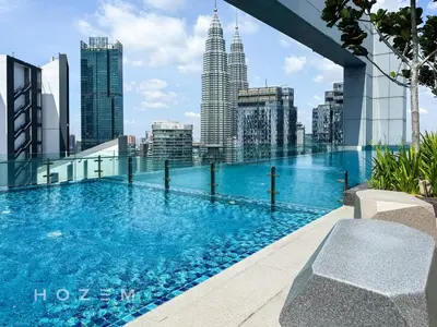 a swimming pool on the roof of a building with a city skyline at 2BR2B Hozem KL5009 Apartment KLCC in Kuala Lumpur